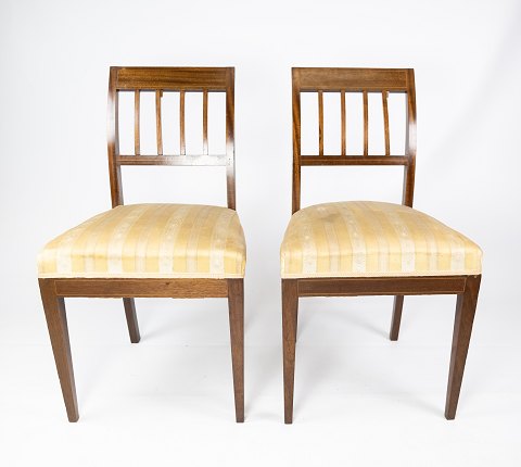 A pair of dining room chairs of mahogany with inlaid wood upholstered with light 
fabric from the 1920s.
5000m2 showroom.
